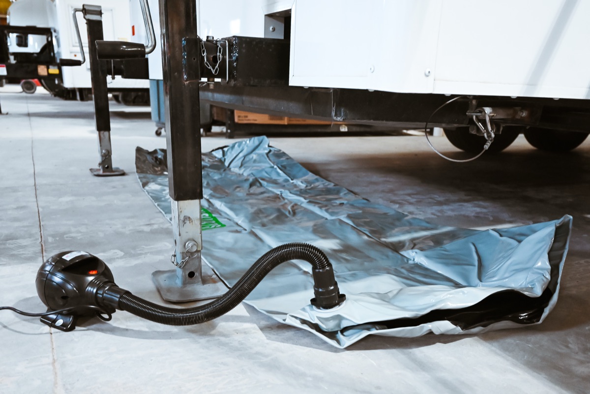 Heat Lock winterization air skirts deployed under restroom trailer